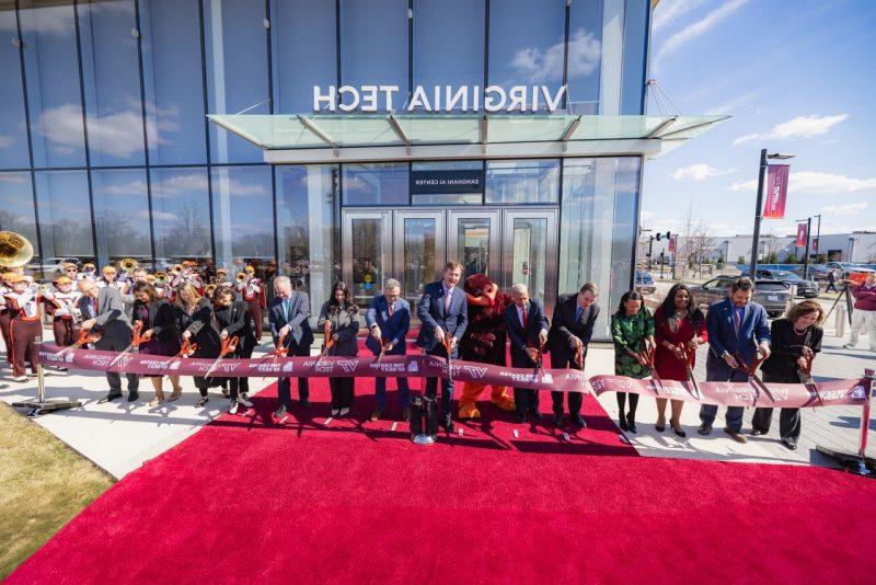 People cut a ribbon marking the entrance to a new building.